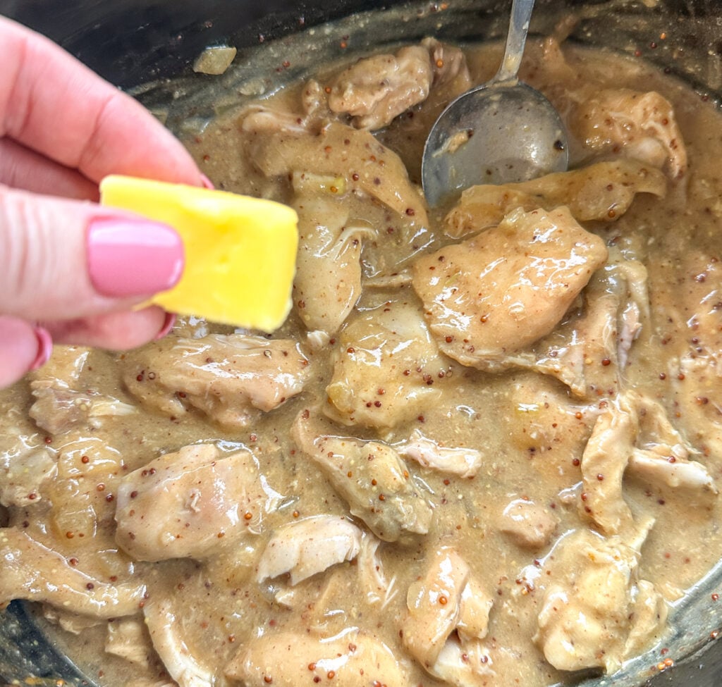 adding butter to the honey mustard chicken i in the slow cooker