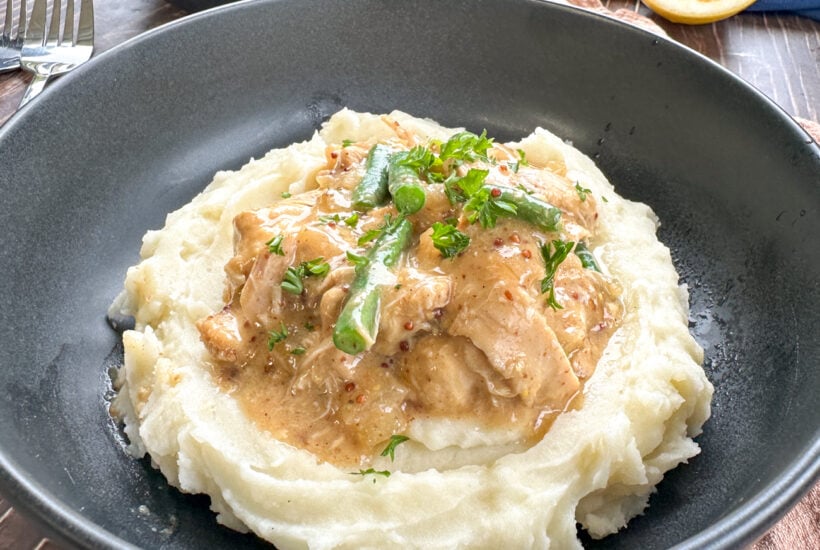 plate of mashed potato topped with honey mustard chicken