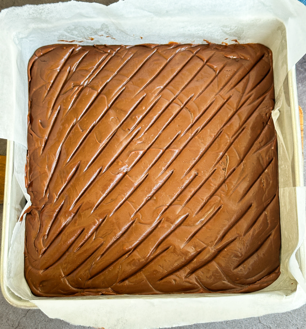 milk chocolate fudge in a lined tin before setting