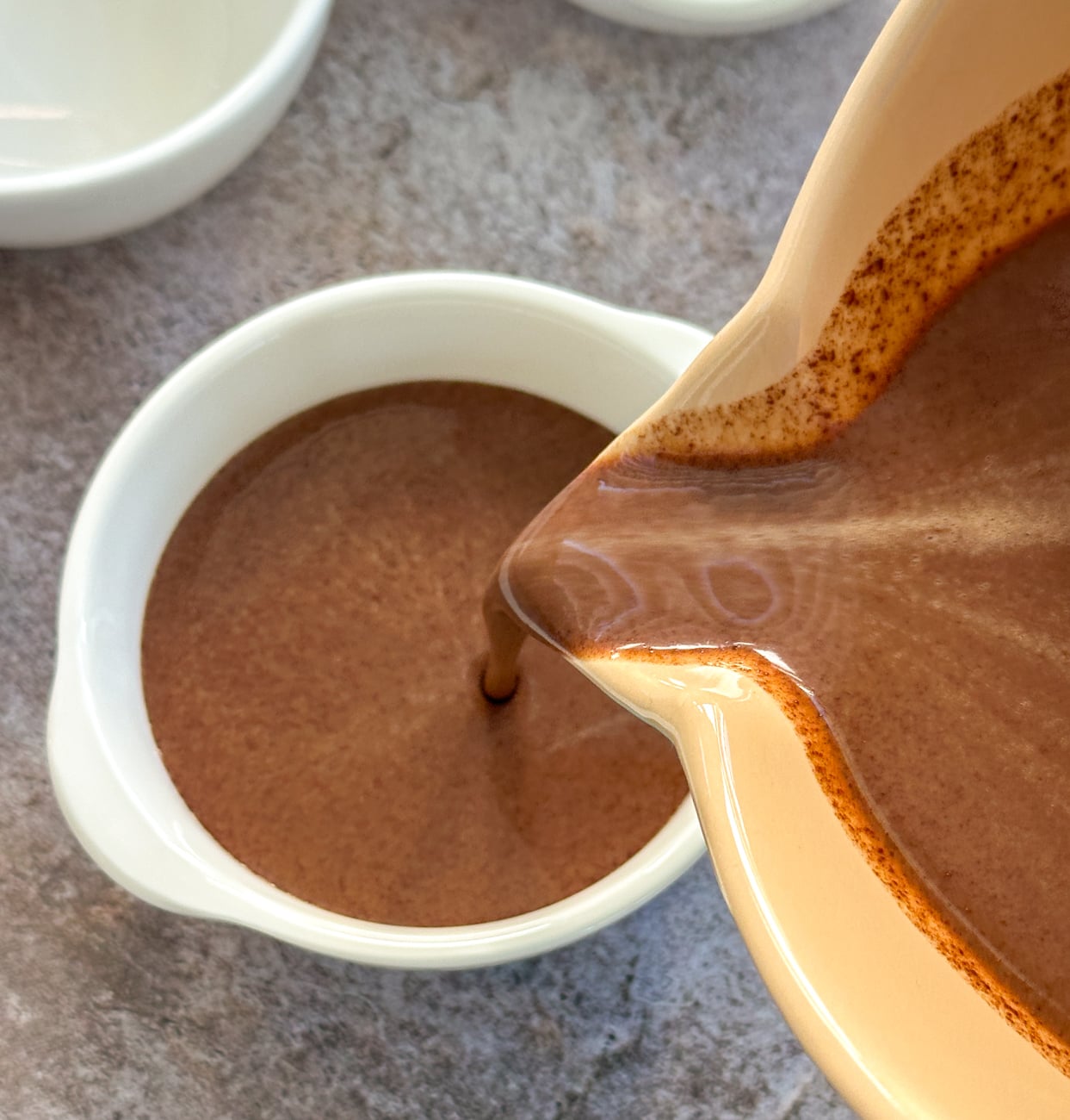 pouring the chocolate into the ramekins