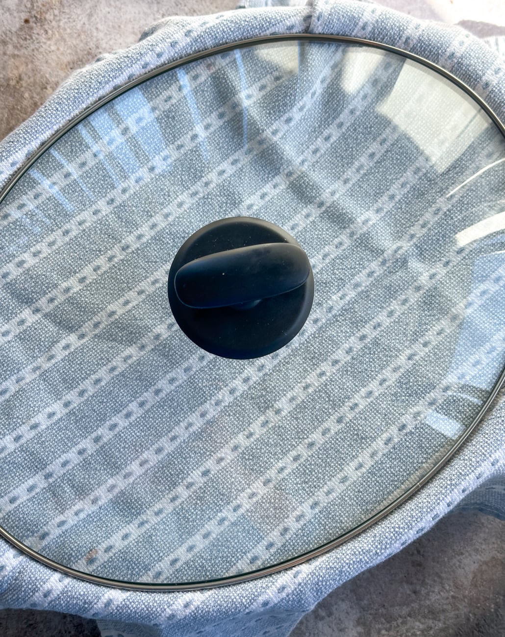 adding a tea towel under a slow cooker lid to stop condensation