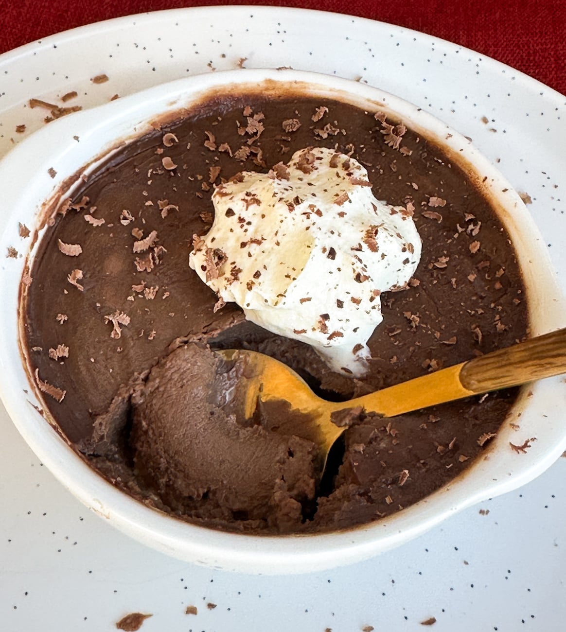 silky rich chocolate pots with a spoon digging into it.