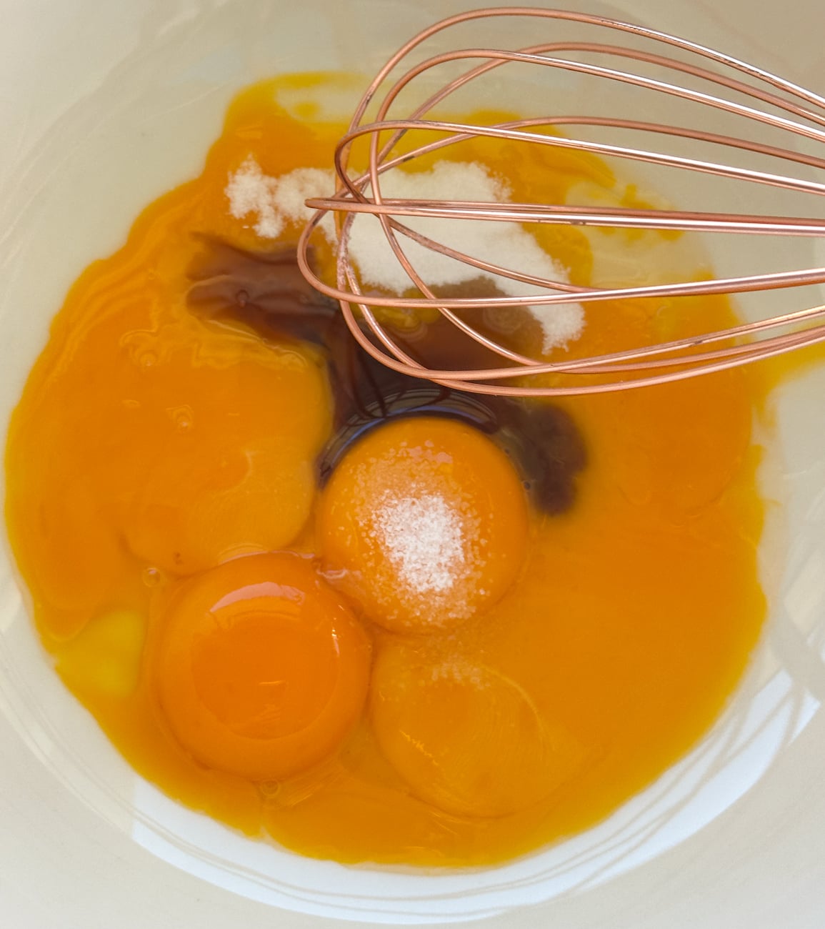 whisk together the egg yolks with the vanilla and sugar and salt