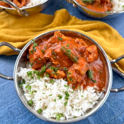 Bowl of tomato chicken curry over rice.