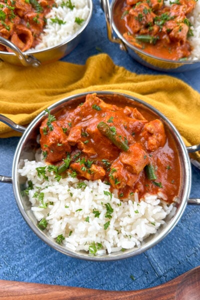 Bowl of tomato chicken curry over rice.