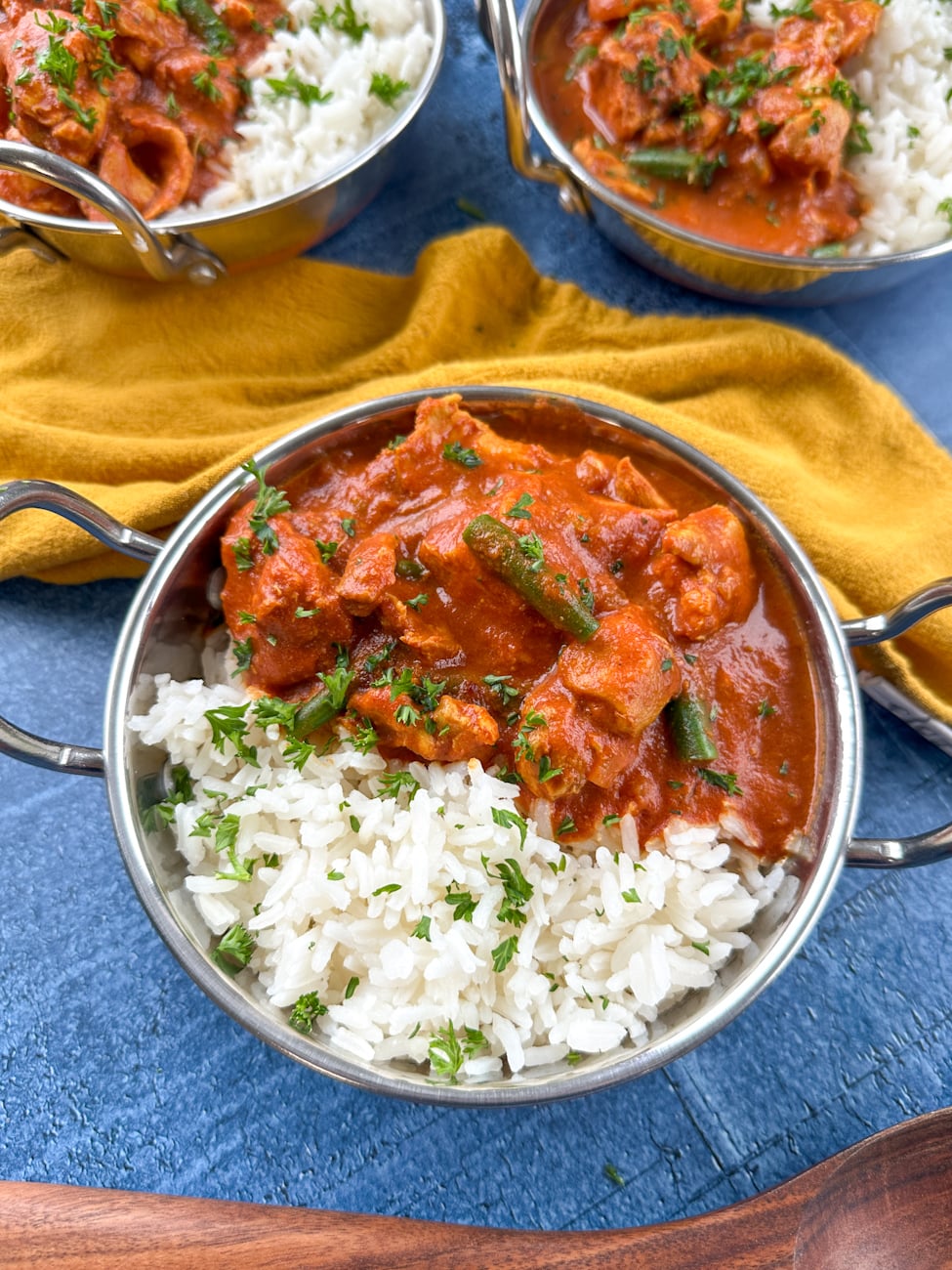 Bowl of tomato chicken curry over rice.