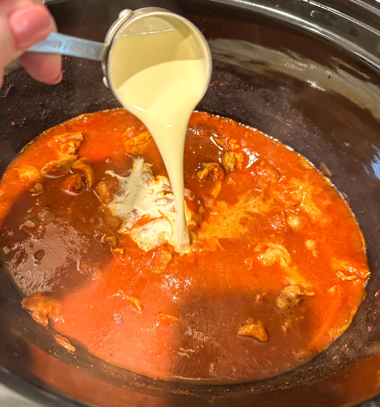 adding in cream and cornflour to the finished curry to thicken