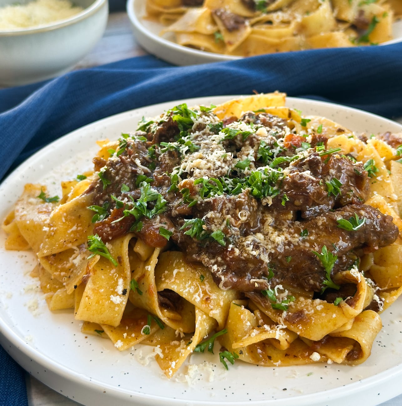 plate of slow cooker beef ragu over pasta