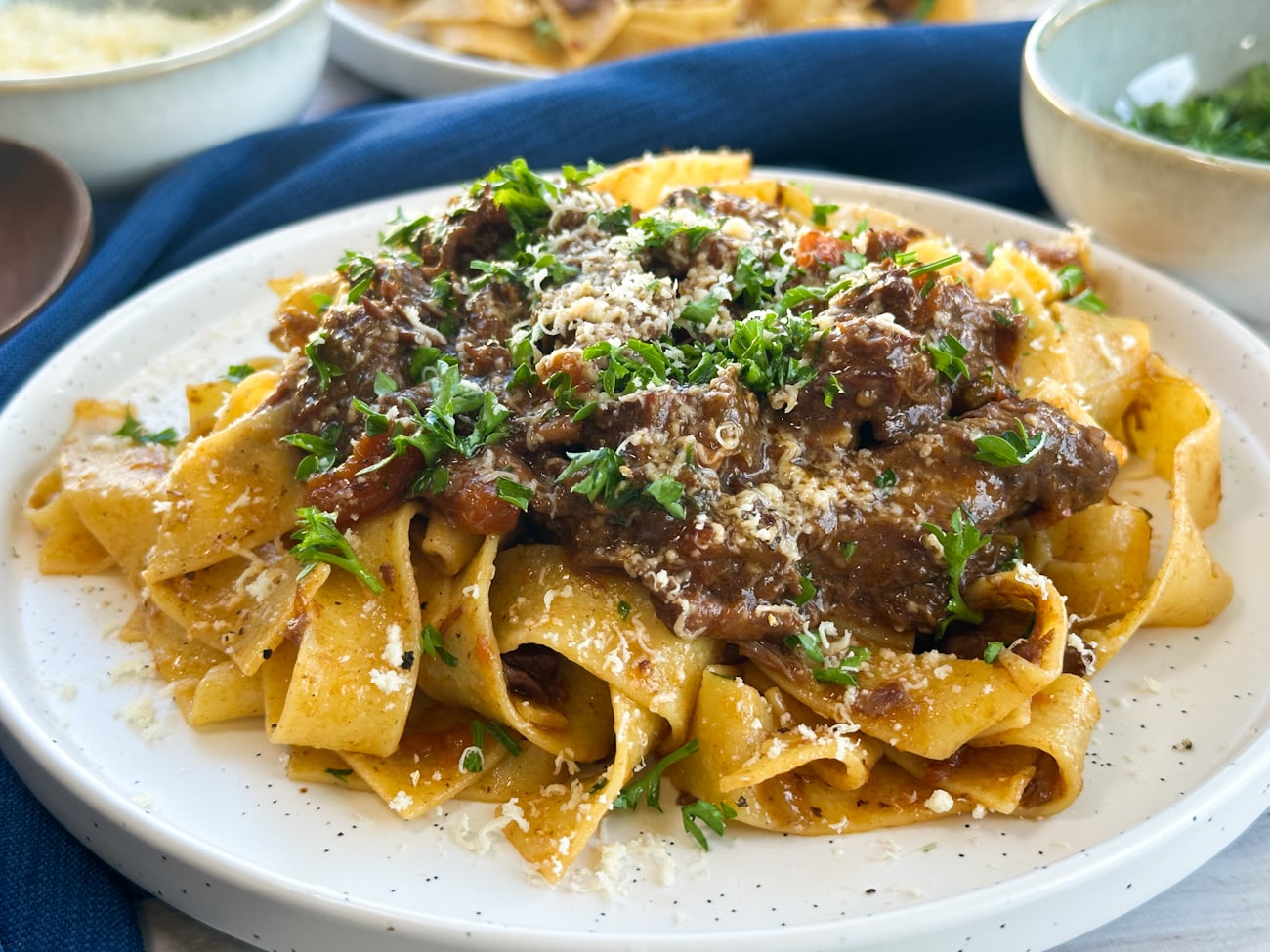Plate of beef ragu on wide pasta