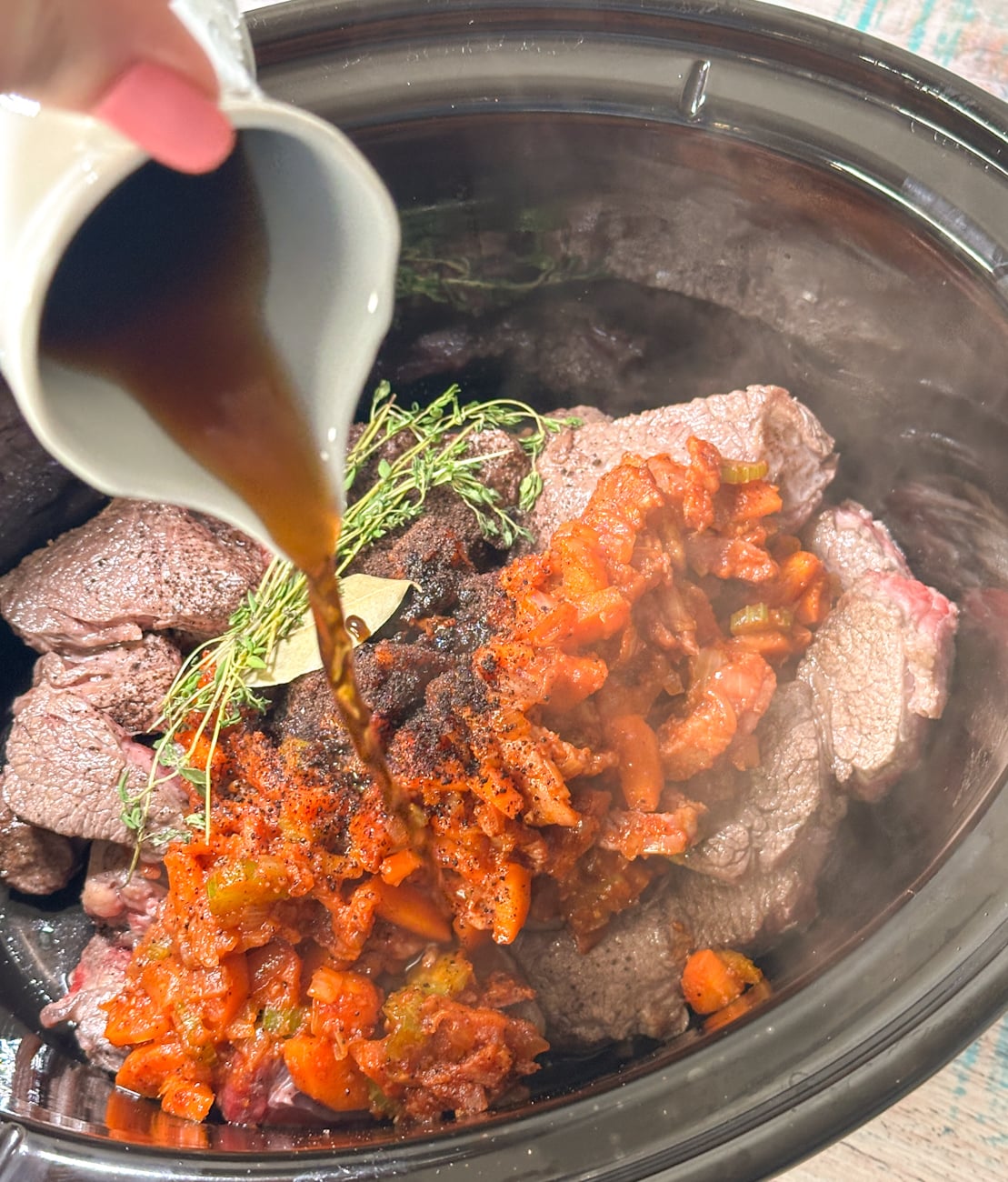 adding all the ingredients to the slow cooker