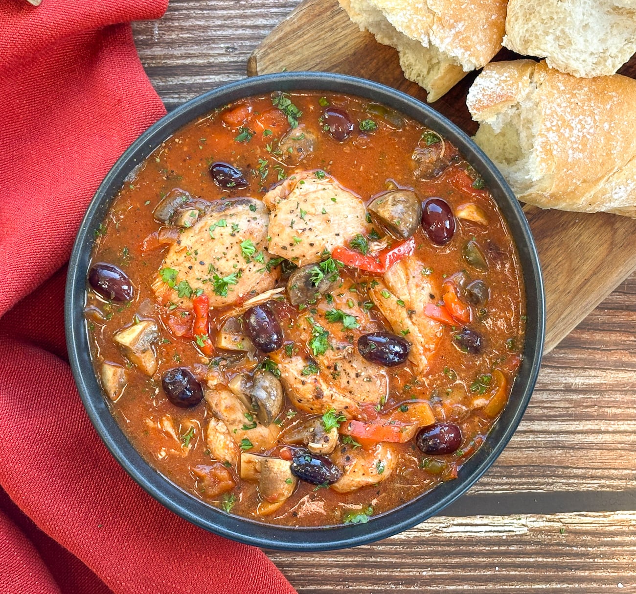bowl of chicken cacciatore slow cooked on a wooden table