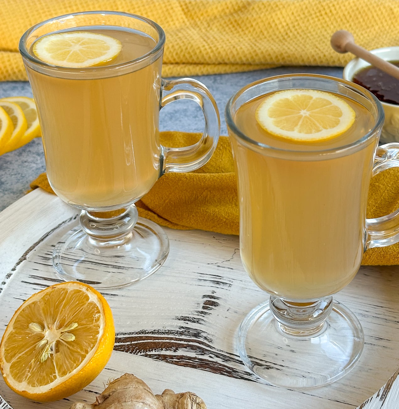 two glasses of warm lemon honey ginger drink