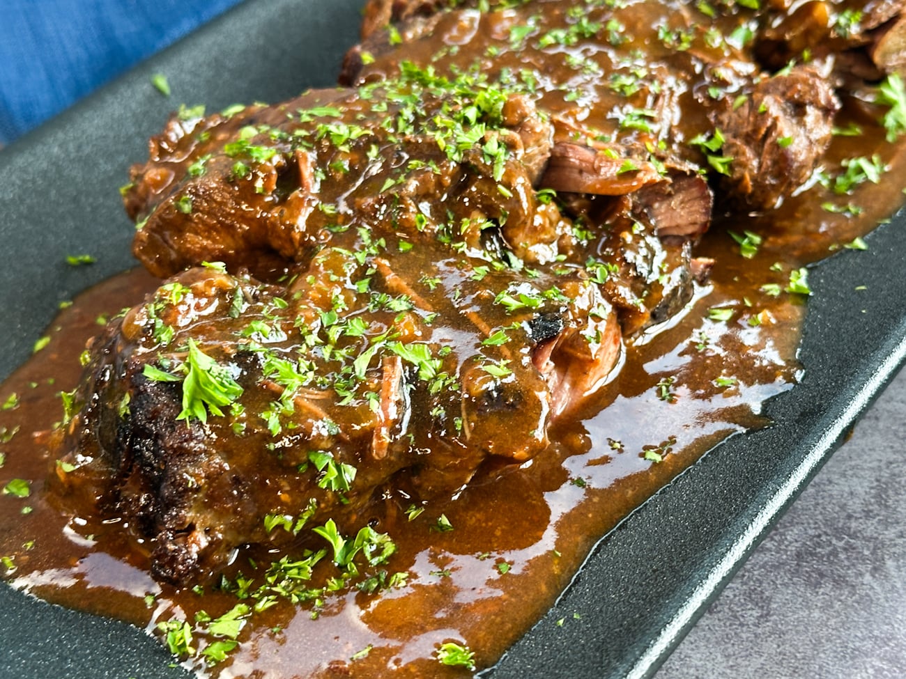 rich beef cheeks in a red wine gravy with parsley