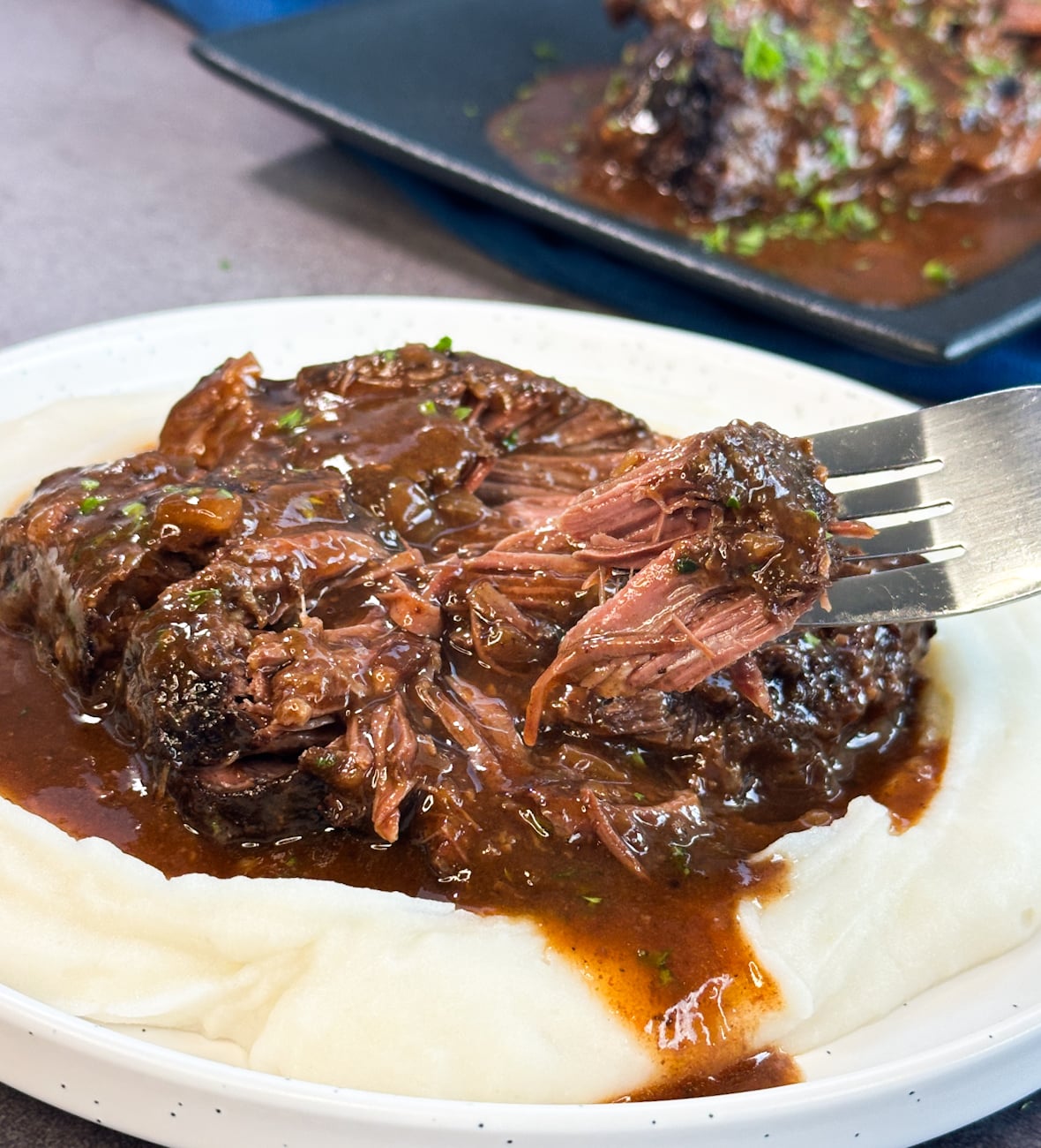 fall apart beef cheeks being pulled with a fork