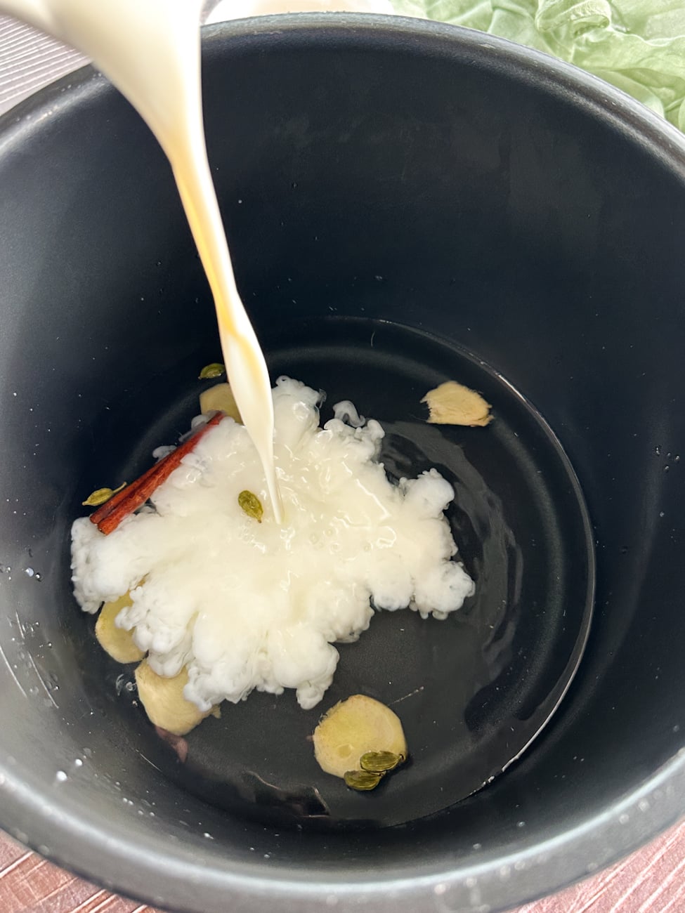 add the milk and water to the spices in the slow cooker