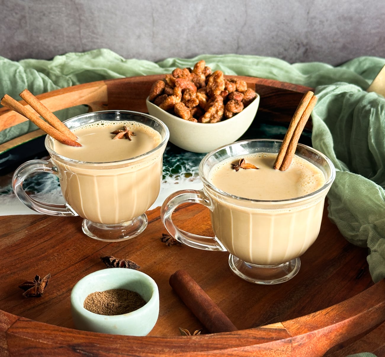 mugs of spiced chai served with cinnamon sticks