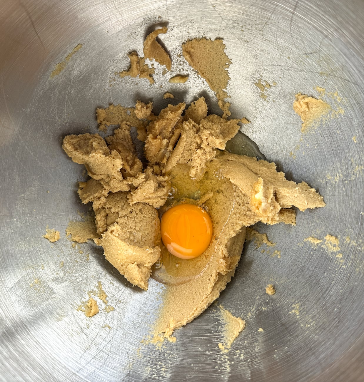 adding eggs one at a time to the sugar and butter mixture