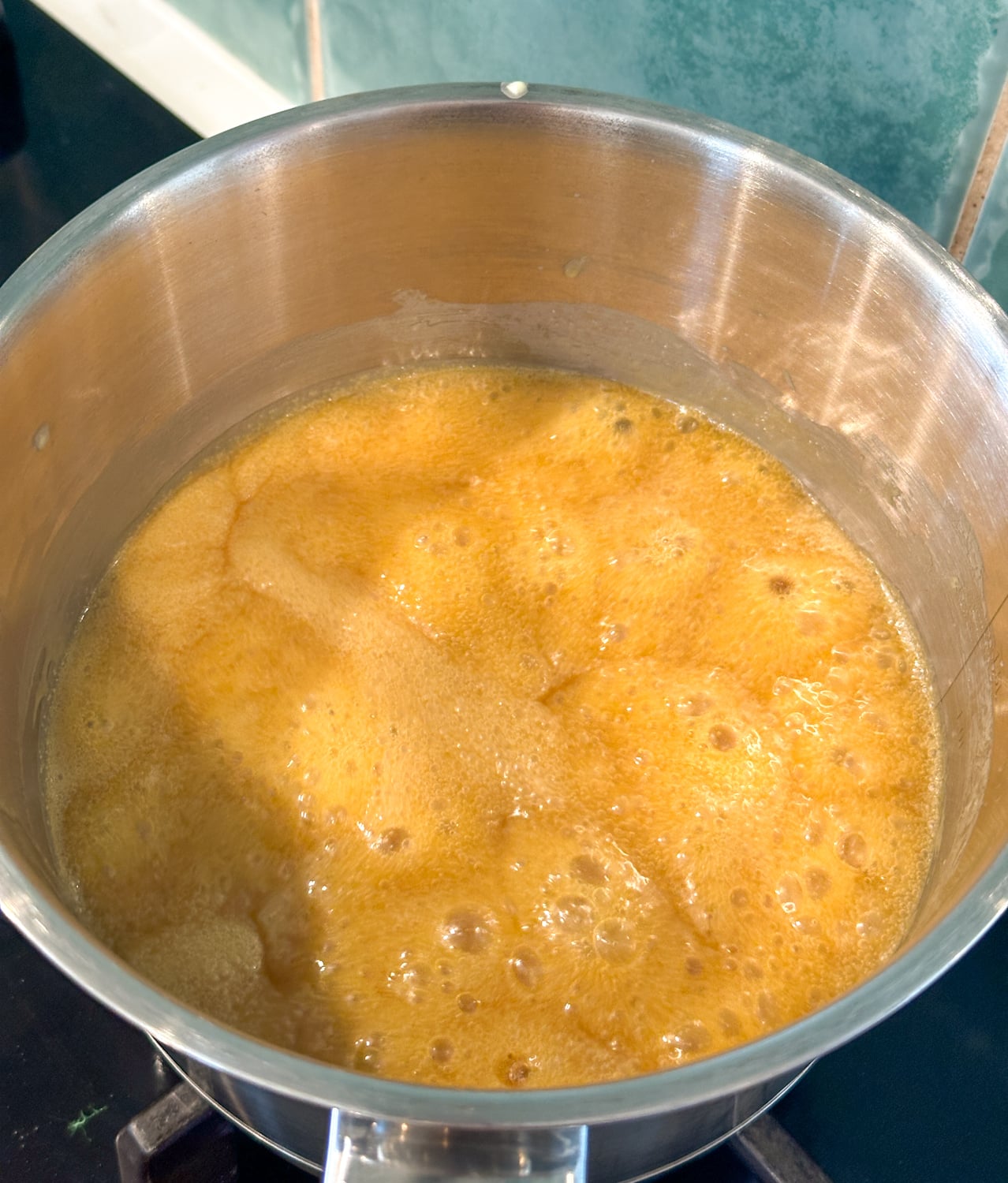 caramel sauce rapidly boiling on the stove top