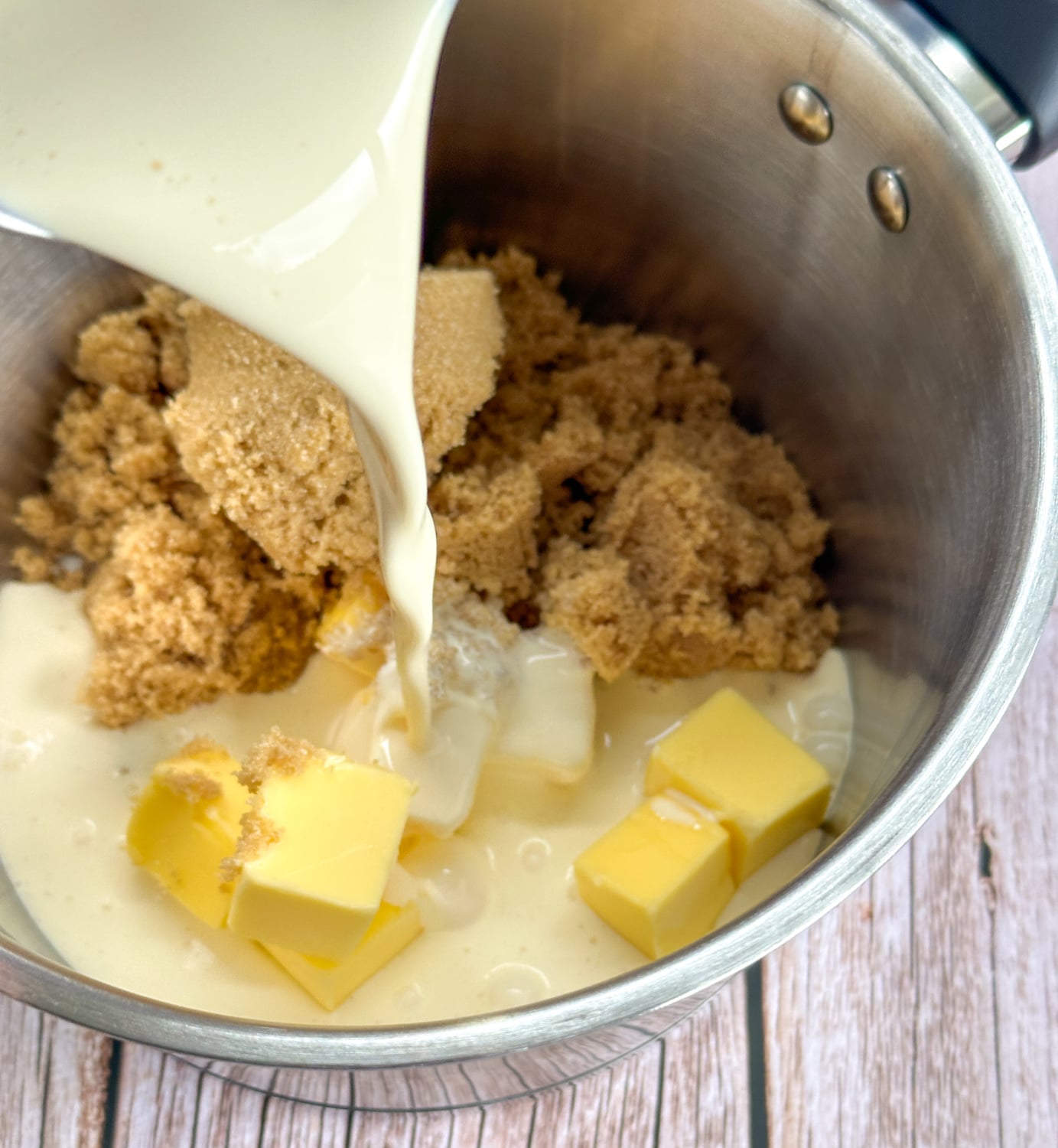 adding ingredients to the saucepan for caramel sauce